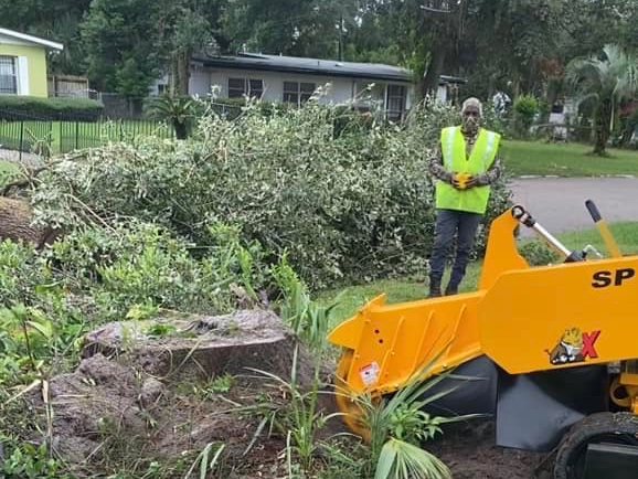 Grinding equipment working a wooded Jacksonville lot